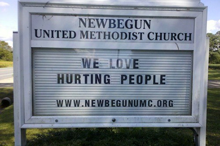 Church sign which reads We love hurting people